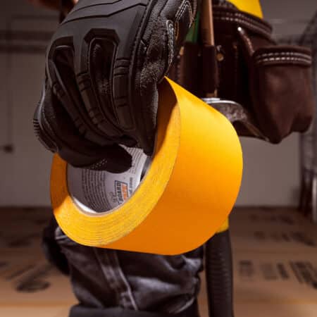 worker holding ram board seam tape