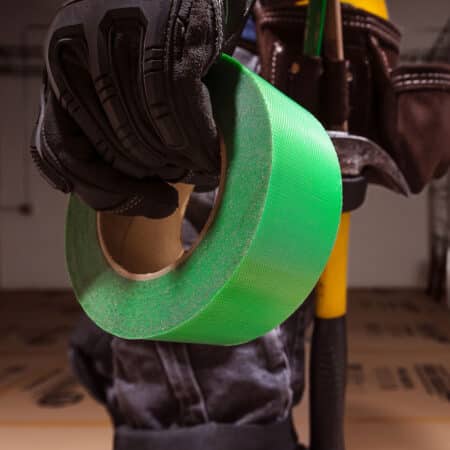 worker holding edge tape