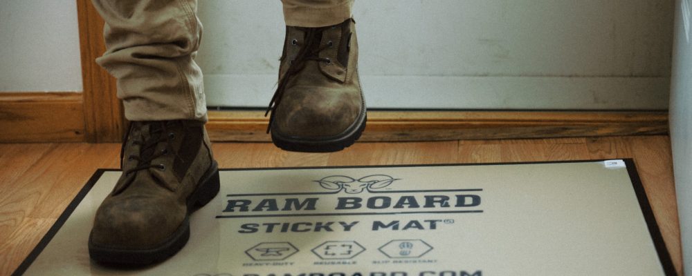 Boots walking on ram board sticky mat