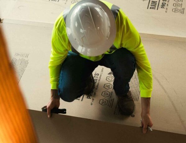 worker putting down ram board pro sheets